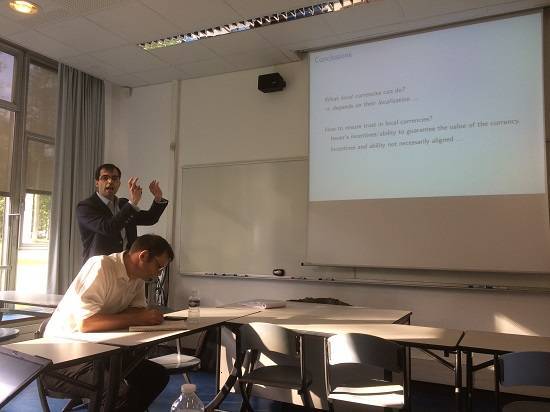 HEC Assistant Professor Eric Mengus leading a workshop on local currency in Les Mureaux with Rob Hopkins taking notes