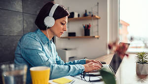 woman working on her computer at home - ©kerkezz / Adobe Stock