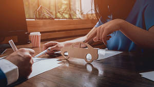 woman working on auto business on a desk - Adobe Stock