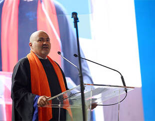 Man standing at a podium, delivering a speech or presentation