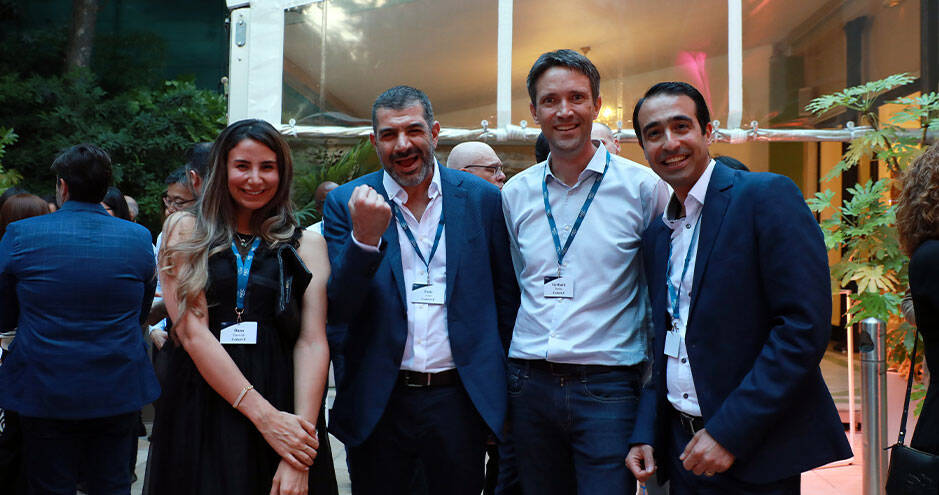 Four professionals, two men and two women, posing for a picture in a professional setting